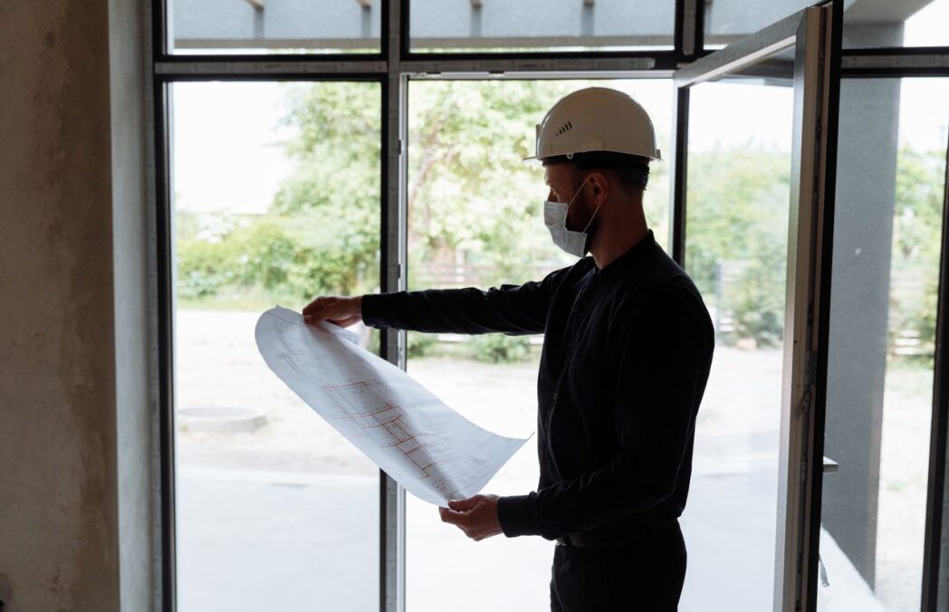 Construction team reviewing permit documents and site plans.