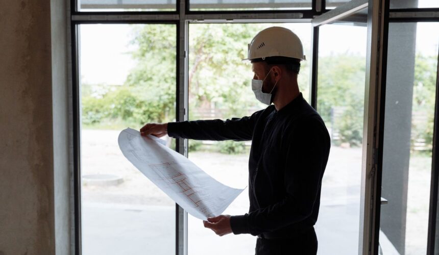 Construction team reviewing permit documents and site plans.