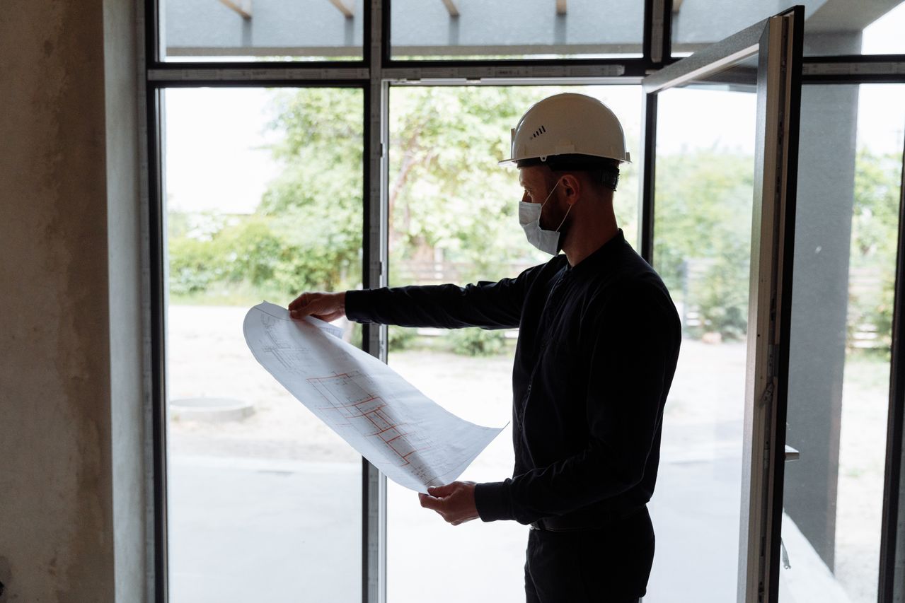 Construction team reviewing permit documents and site plans.
