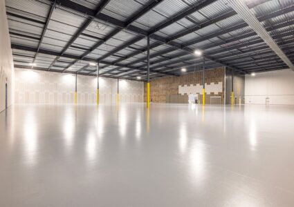Empty modern warehouse interior with polished floor