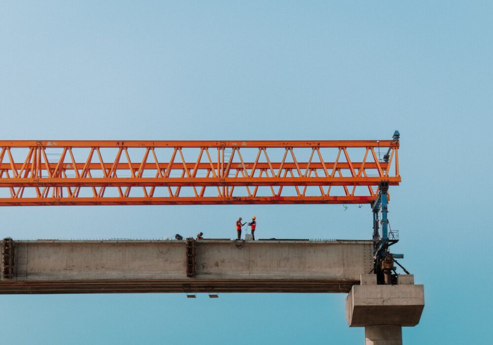 Construction workers on an elevated bridge i
