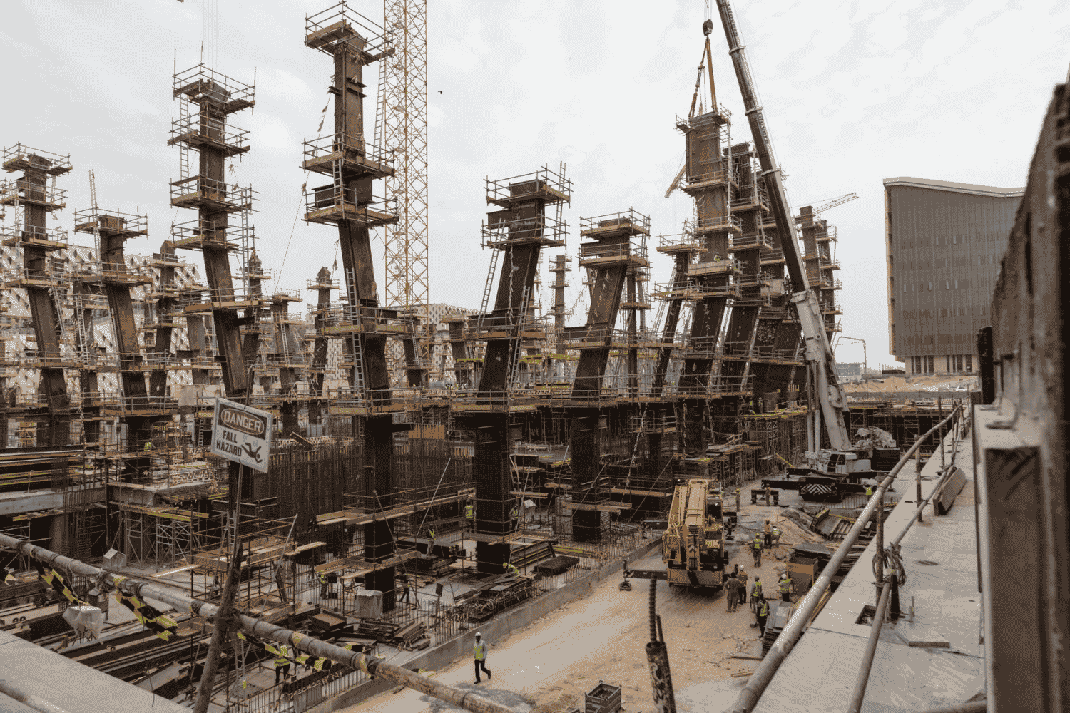 construction site with towering steel frameworks and cranes