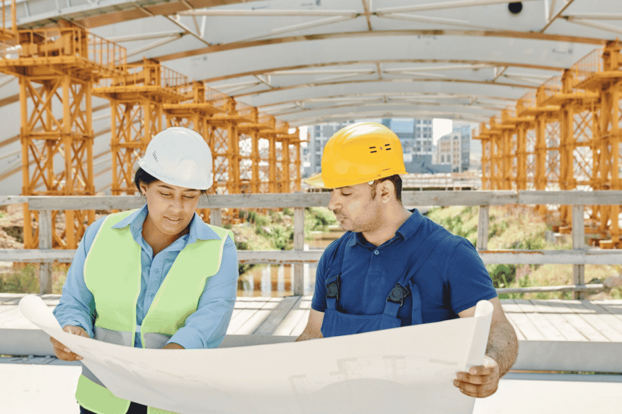 industrial construction team reviewing project plans on site