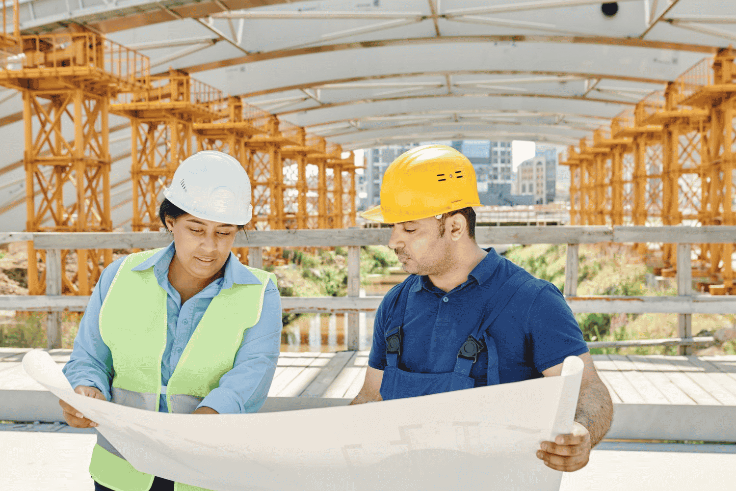 industrial construction team reviewing project plans on site